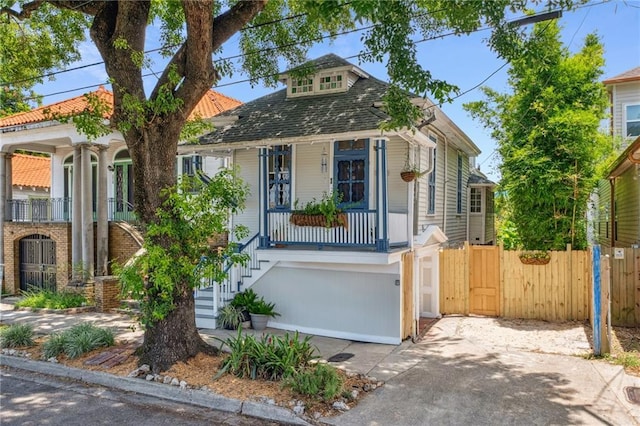 1714 N Broad St, New Orleans, LA 70119 - view of front of house featuring covered porch, stairs, concrete driveway, and a gate