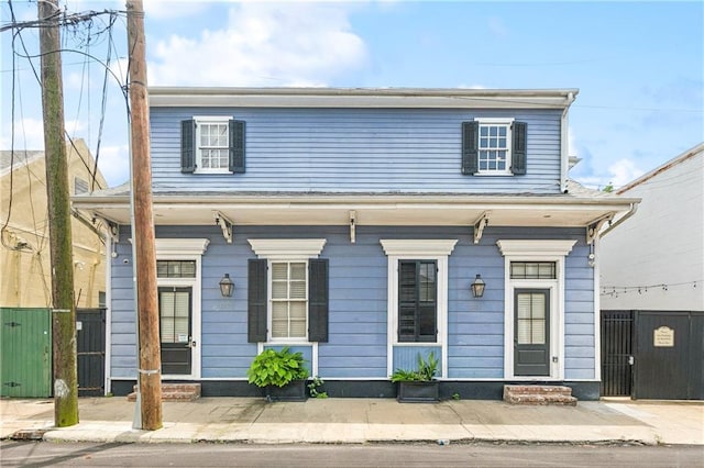 1030 Kerlerec St Unit 4, New Orleans, LA 70116 - view of front facade featuring covered porch and a gate