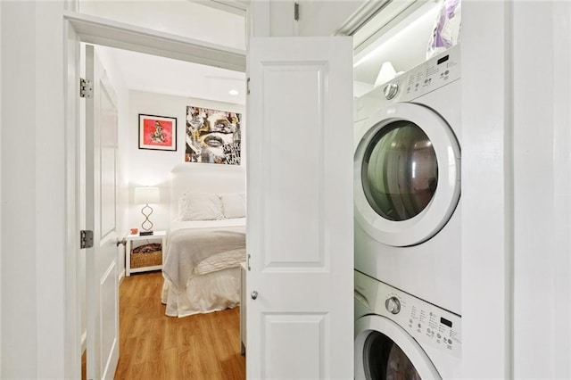 6945 Milne Blvd, New Orleans, LA 70124 - laundry area with stacked washing machine and dryer and light wood-style flooring