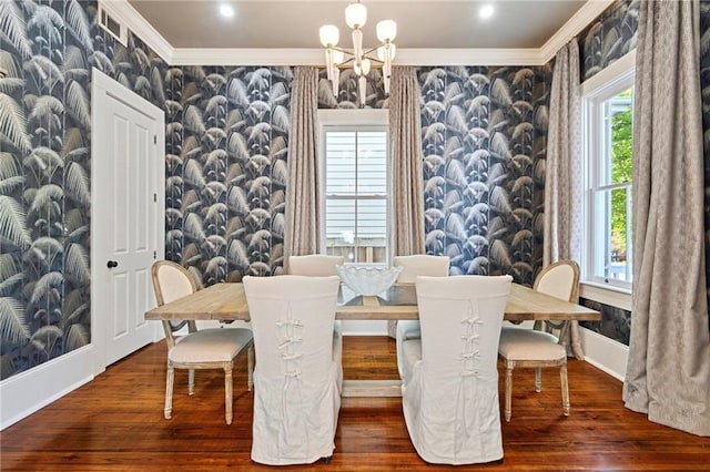 1215 Saint Andrew St, New Orleans, LA 70130 - dining area with a chandelier, crown molding, wood finished floors, baseboards, and wallpapered walls