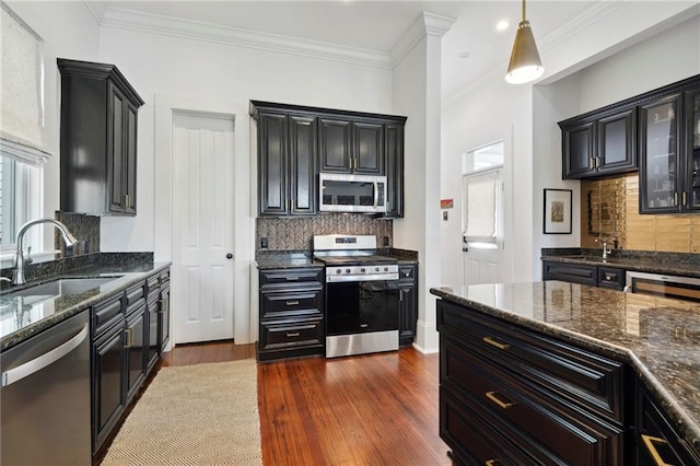 1215 Saint Andrew St, New Orleans, LA 70130 - kitchen featuring stainless steel appliances, a sink, plenty of natural light, dark wood-type flooring, and ornamental molding