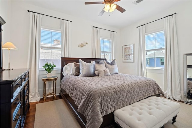 1215 Saint Andrew St, New Orleans, LA 70130 - bedroom with multiple windows, dark wood-style floors, and ceiling fan