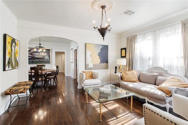 1510 Camp St, New Orleans, LA 70130 - living area with arched walkways, a chandelier, and wood finished floors