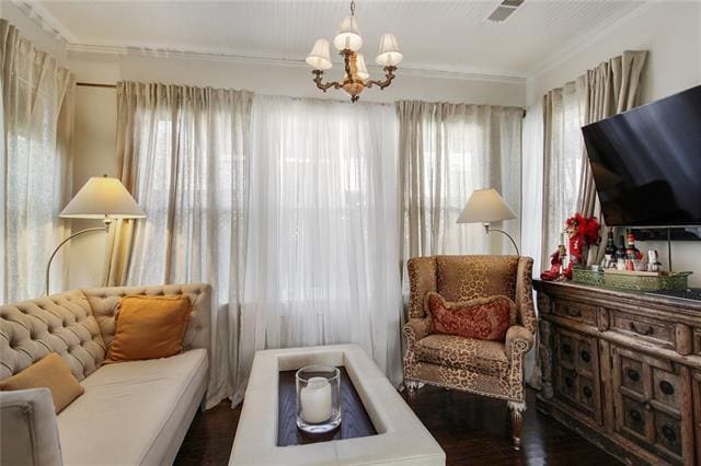 1510 Camp St, New Orleans, LA 70130 - living area with a chandelier, wood finished floors, and ornamental molding