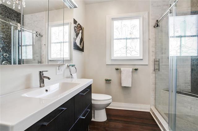 1510 Camp St, New Orleans, LA 70130 - full bath with vanity, toilet, baseboards, and a shower stall