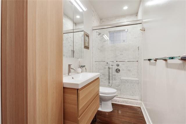1510 Camp St, New Orleans, LA 70130 - full bath featuring toilet, a shower stall, vanity, and wood finished floors