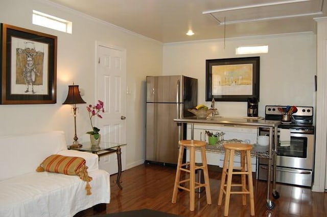 1510 Camp St, New Orleans, LA 70130 - kitchen featuring appliances with stainless steel finishes, wood finished floors, ornamental molding, and baseboards