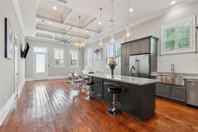 4823 Dreux Ave, New Orleans, LA 70126 - kitchen with stainless steel appliances, a sink, gray cabinetry, open floor plan, and beamed ceiling