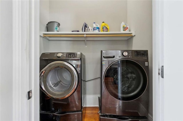 4823 Dreux Ave, New Orleans, LA 70126 - washroom featuring washing machine and dryer and wood finished floors