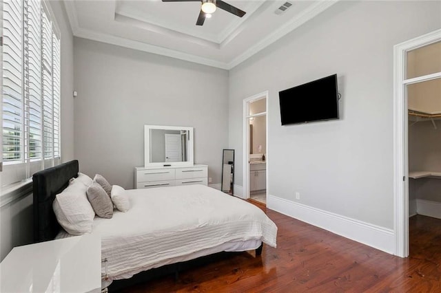 4823 Dreux Ave, New Orleans, LA 70126 - bedroom with a spacious closet, wood finished floors, crown molding, a tray ceiling, and a ceiling fan