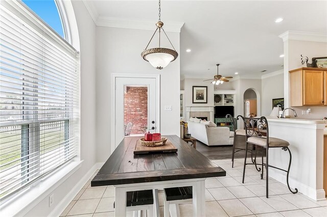 1115 Primrose Dr, Boutte, LA 70039 - dining area featuring light tile patterned floors, ceiling fan, built in shelves, a fireplace, and recessed lighting