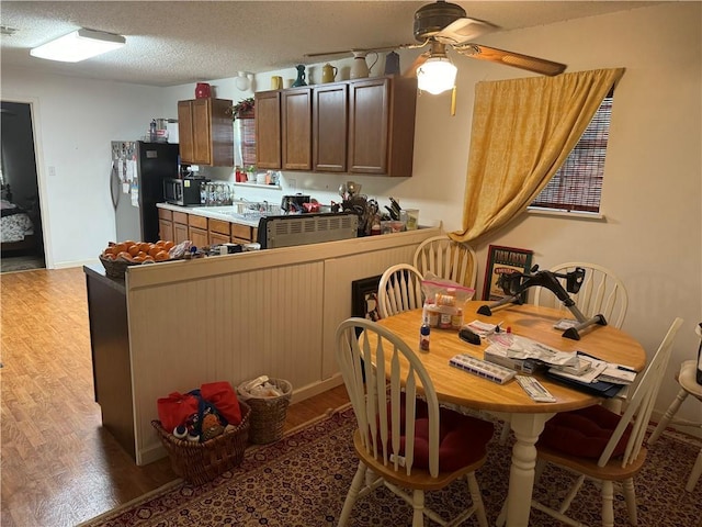 805 W Howze Beach Rd, Slidell, LA 70458 - dining area with wood finished floors, ceiling fan, and a textured ceiling