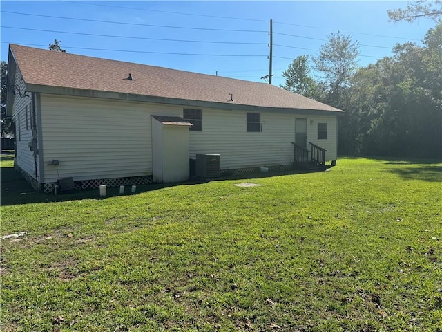 805 W Howze Beach Rd, Slidell, LA 70458 - rear view of house with entry steps, a yard, central air condition unit, and a shingled roof