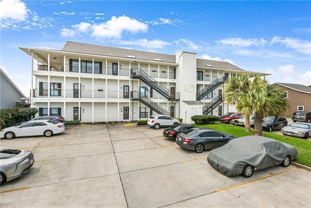 1163 Marina Dr Unit 1163, Slidell, LA 70458 - view of building exterior with uncovered parking and stairway