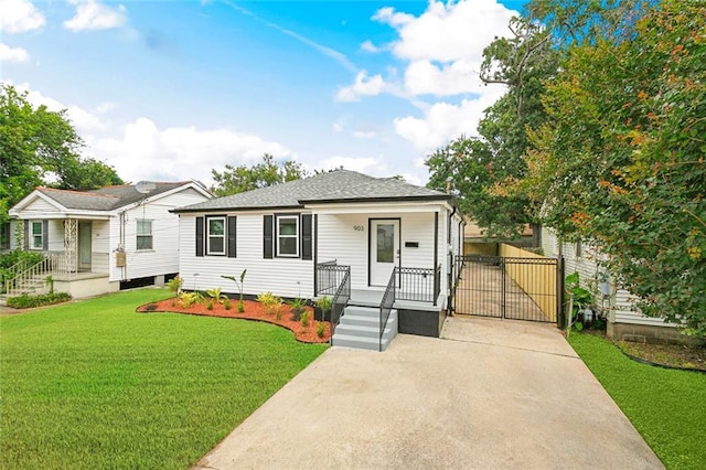 903 N Turnbull Dr, Metairie, LA 70001 - view of front of house with a gate, a front lawn, roof with shingles, and a porch
