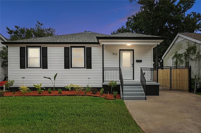903 N Turnbull Dr, Metairie, LA 70001 - view of front of home with a porch, a shingled roof, and a front yard