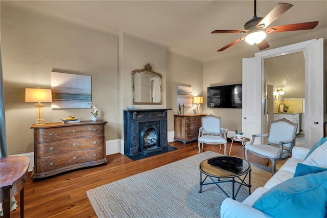515 Saint Louis St Unit 6, New Orleans, LA 70130 - living area featuring wood-type flooring, a ceiling fan, and a fireplace with flush hearth