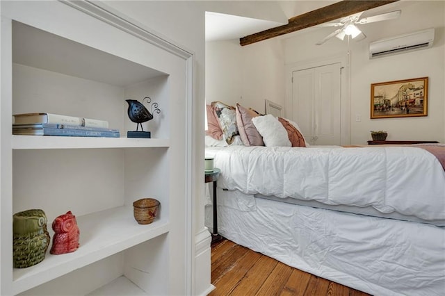 515 Saint Louis St Unit 6, New Orleans, LA 70130 - bedroom with a wall mounted air conditioner, wood finished floors, ceiling fan, and a closet