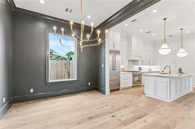 1617 Homer St, Metairie, LA 70005 - kitchen with high quality appliances, custom exhaust hood, white cabinets, a sink, and light countertops