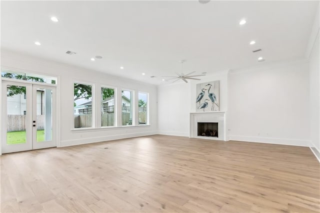 1617 Homer St, Metairie, LA 70005 - unfurnished living room featuring crown molding, light wood finished floors, french doors, a fireplace, and baseboards