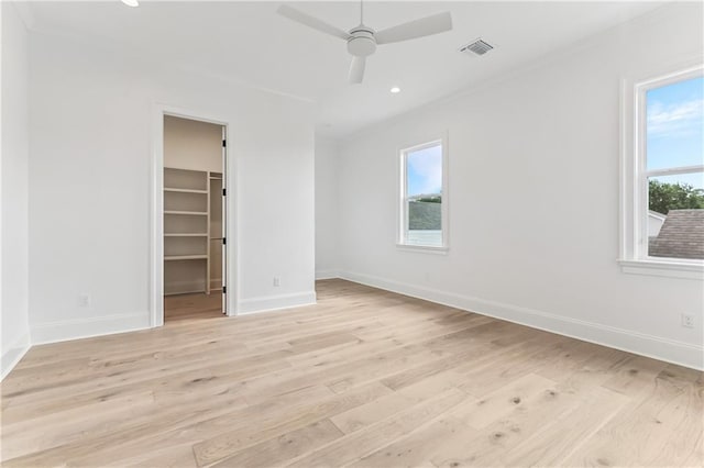 1617 Homer St, Metairie, LA 70005 - unfurnished bedroom featuring crown molding, light wood-style flooring, baseboards, a walk in closet, and recessed lighting