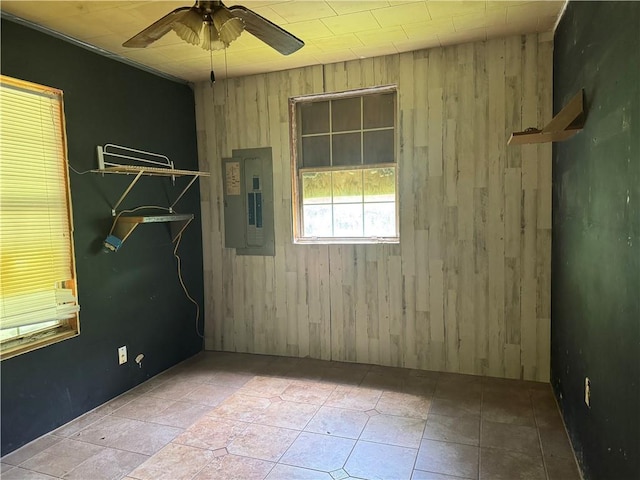27060 Pichon Rd, Lacombe, LA 70445 - unfurnished room featuring electric panel, a ceiling fan, and wooden walls