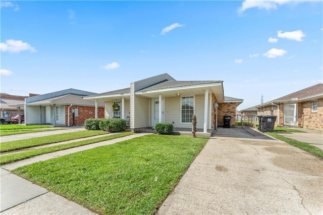 9101-9103 Atreus St, Chalmette, LA 70043 - single story home with driveway, a front yard, brick siding, and a gate