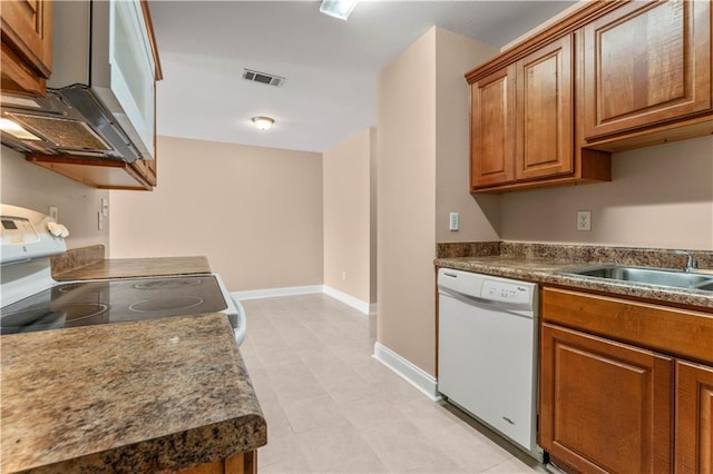 9101-9103 Atreus St, Chalmette, LA 70043 - kitchen with white appliances, brown cabinetry, baseboards, light tile patterned flooring, and a sink