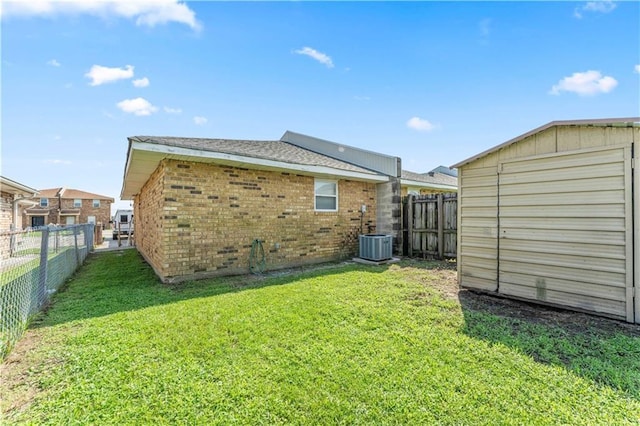 9101-9103 Atreus St, Chalmette, LA 70043 - back of property featuring brick siding, an outbuilding, and cooling unit