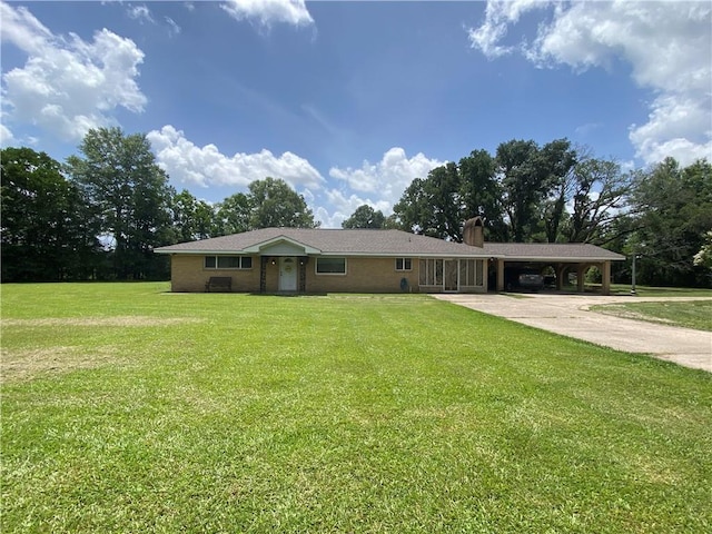 10116 16th Hwy, Amite, LA 70422 - ranch-style house featuring concrete driveway, a chimney, a carport, and a front lawn