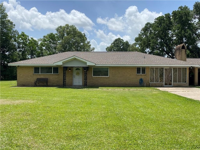 10116 16th Hwy, Amite, LA 70422 - ranch-style home with a front yard, a chimney, brick siding, and roof with shingles