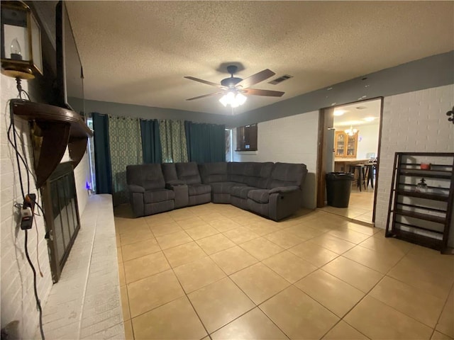 10116 16th Hwy, Amite, LA 70422 - living area featuring light tile patterned floors, a fireplace, a textured ceiling, and a ceiling fan