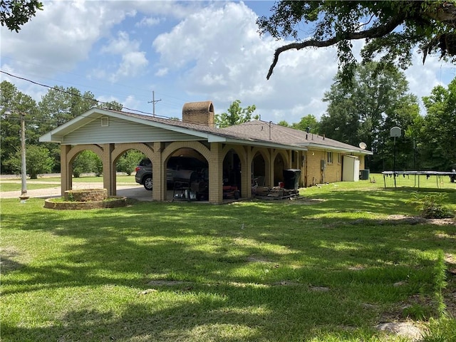 10116 16th Hwy, Amite, LA 70422 - view of property's community featuring a trampoline, a yard, and a garage