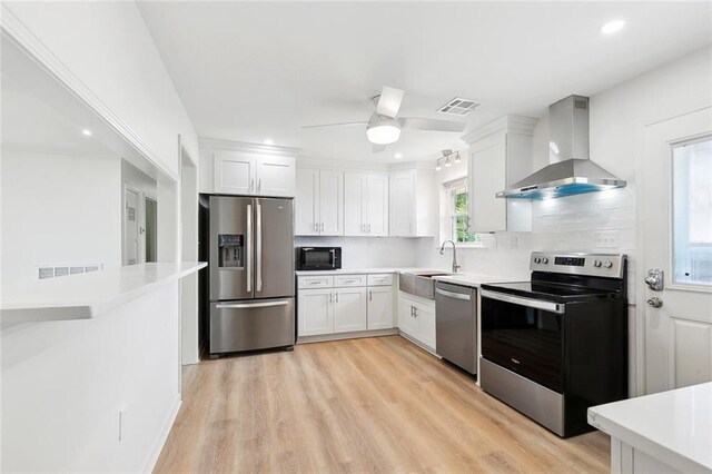 2320 Roosevelt Blvd, Kenner, LA 70062 - kitchen featuring stainless steel appliances, ventilation hood, a sink, white cabinetry, and ceiling fan