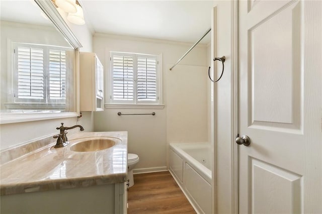 2320 Roosevelt Blvd, Kenner, LA 70062 - bathroom featuring vanity, toilet,  shower combination, wood finished floors, and crown molding