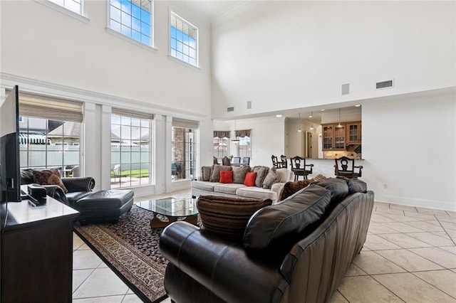 5 Asterbrook Ct, Harvey, LA 70058 - living area featuring a towering ceiling, light tile patterned flooring, crown molding, and baseboards