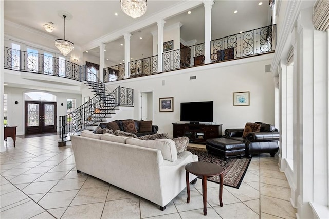 5 Asterbrook Ct, Harvey, LA 70058 - living room with a towering ceiling, light tile patterned flooring, stairs, french doors, and decorative columns