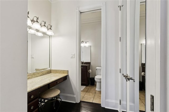 5 Asterbrook Ct, Harvey, LA 70058 - bathroom with toilet, vanity, ornamental molding, wood finished floors, and baseboards