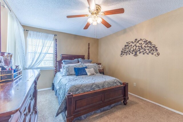 2425 Oxford Pl Unit 139, Gretna, LA 70056 - bedroom with a textured ceiling, carpet, baseboards, and a ceiling fan