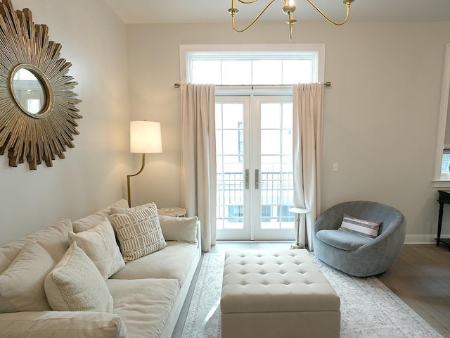 731 St Charles Ave Unit 305, New Orleans, LA 70130 - living room with wood finished floors, a chandelier, and baseboards