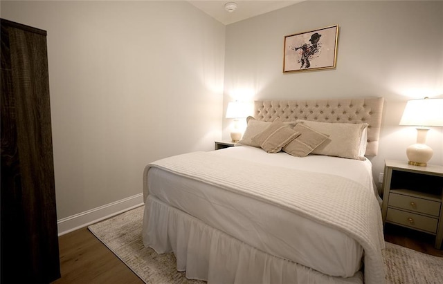 731 St Charles Ave Unit 305, New Orleans, LA 70130 - bedroom with baseboards and wood finished floors