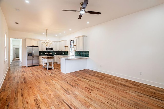 532 Elmira Ave, New Orleans, LA 70114 - kitchen featuring appliances with stainless steel finishes, light wood-style flooring, a chandelier, a peninsula, and decorative backsplash