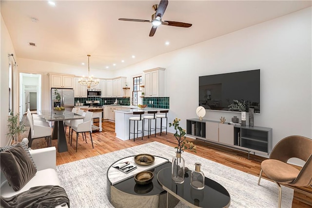 532 Elmira Ave, New Orleans, LA 70114 - living area featuring a chandelier, light wood-style floors, ceiling fan, and recessed lighting