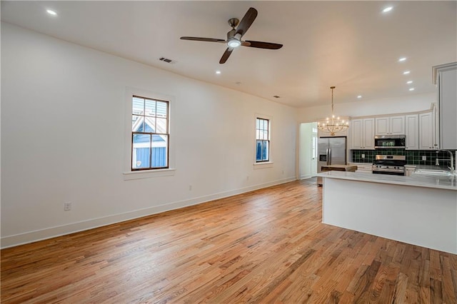 532 Elmira Ave, New Orleans, LA 70114 - kitchen featuring appliances with stainless steel finishes, a chandelier, plenty of natural light, light wood-style flooring, and recessed lighting