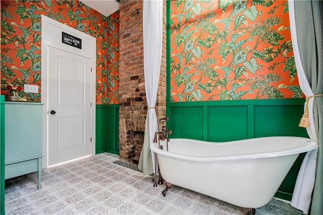 532 Elmira Ave, New Orleans, LA 70114 - bathroom with wallpapered walls, a wainscoted wall, and a freestanding tub