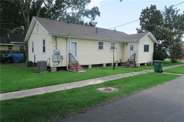 221513 James St, Jefferson, LA 70121 - view of front of property with entry steps, cooling unit, a shingled roof, and a front lawn