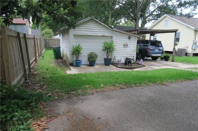 221513 James St, Jefferson, LA 70121 - view of property exterior with an outbuilding, a detached garage, central air condition unit, and a carport