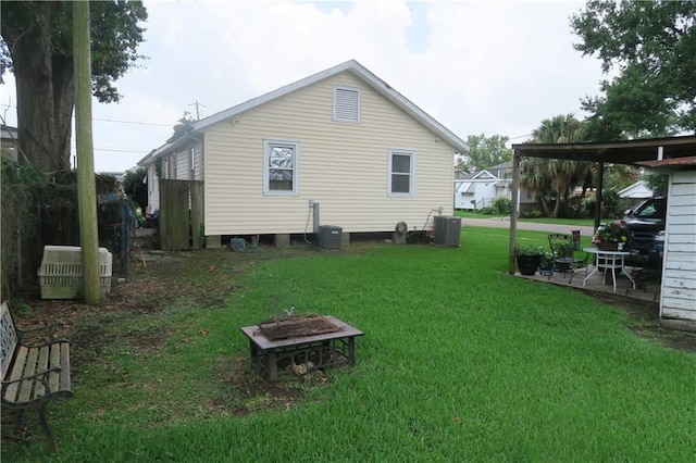 221513 James St, Jefferson, LA 70121 - rear view of property featuring central AC unit, a fire pit, and a yard