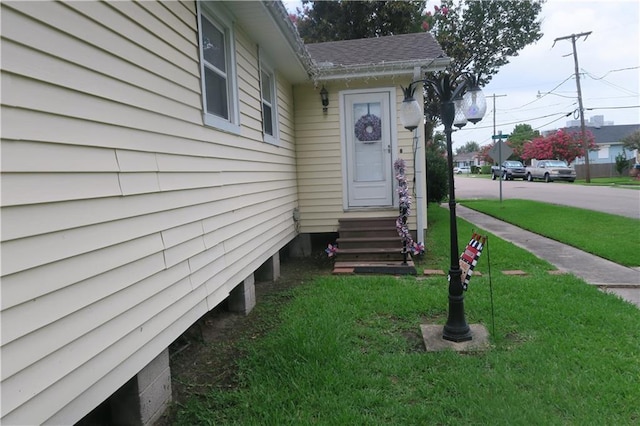 221513 James St, Jefferson, LA 70121 - doorway to property with a lawn and roof with shingles