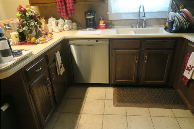 221513 James St, Jefferson, LA 70121 - kitchen with stainless steel dishwasher, backsplash, a sink, light countertops, and dark brown cabinetry